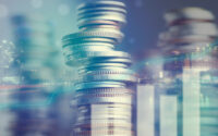 double-exposure-of-city-and-graph-on-rows-of-coins