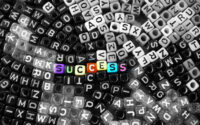 colorful-vivid-success-word-on-black-and-white-alphabet-letter-cubes-background