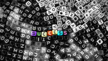 colorful-vivid-success-word-on-black-and-white-alphabet-letter-cubes-background