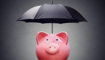 financial-insurance-or-protection-piggy-bank-with-umbrella