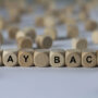 pay-back-cube-with-letters-sign-with-wooden-cubes