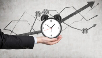 businessmans-hand-holds-an-alarm-clock