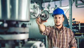 man-using-tablet-at-natural-gas-processing-facility