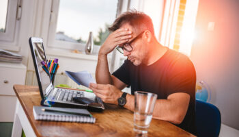 man-reading-letter-and-felling-worried