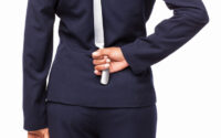 businesswoman-with-a-dagger-behind-back-isolated