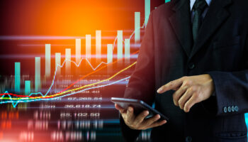 business-man-on-digital-stock-market-financial-indicator-background