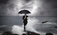 business-man-under-an-umbrella-in-the-sea