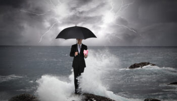business-man-under-an-umbrella-in-the-sea